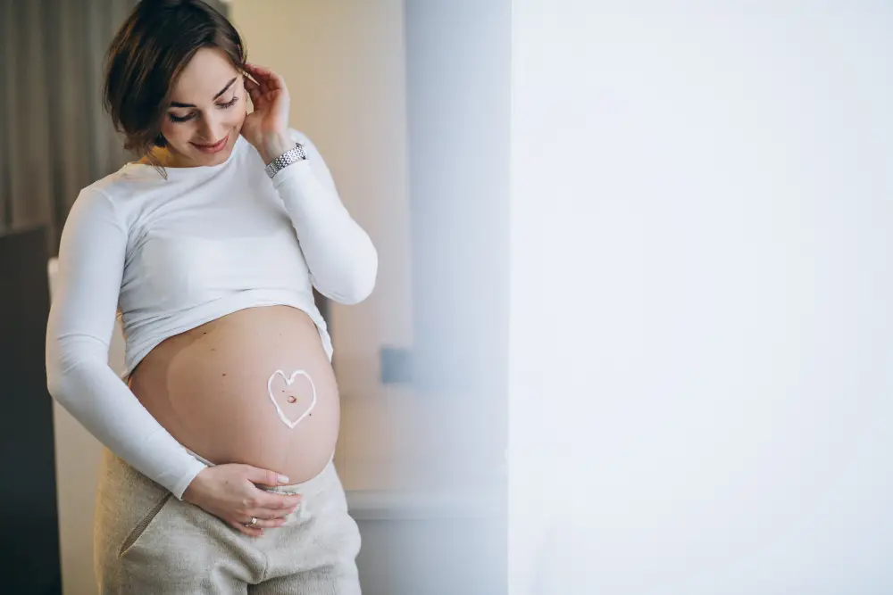 pregnant woman applying cream belly prevent stretches